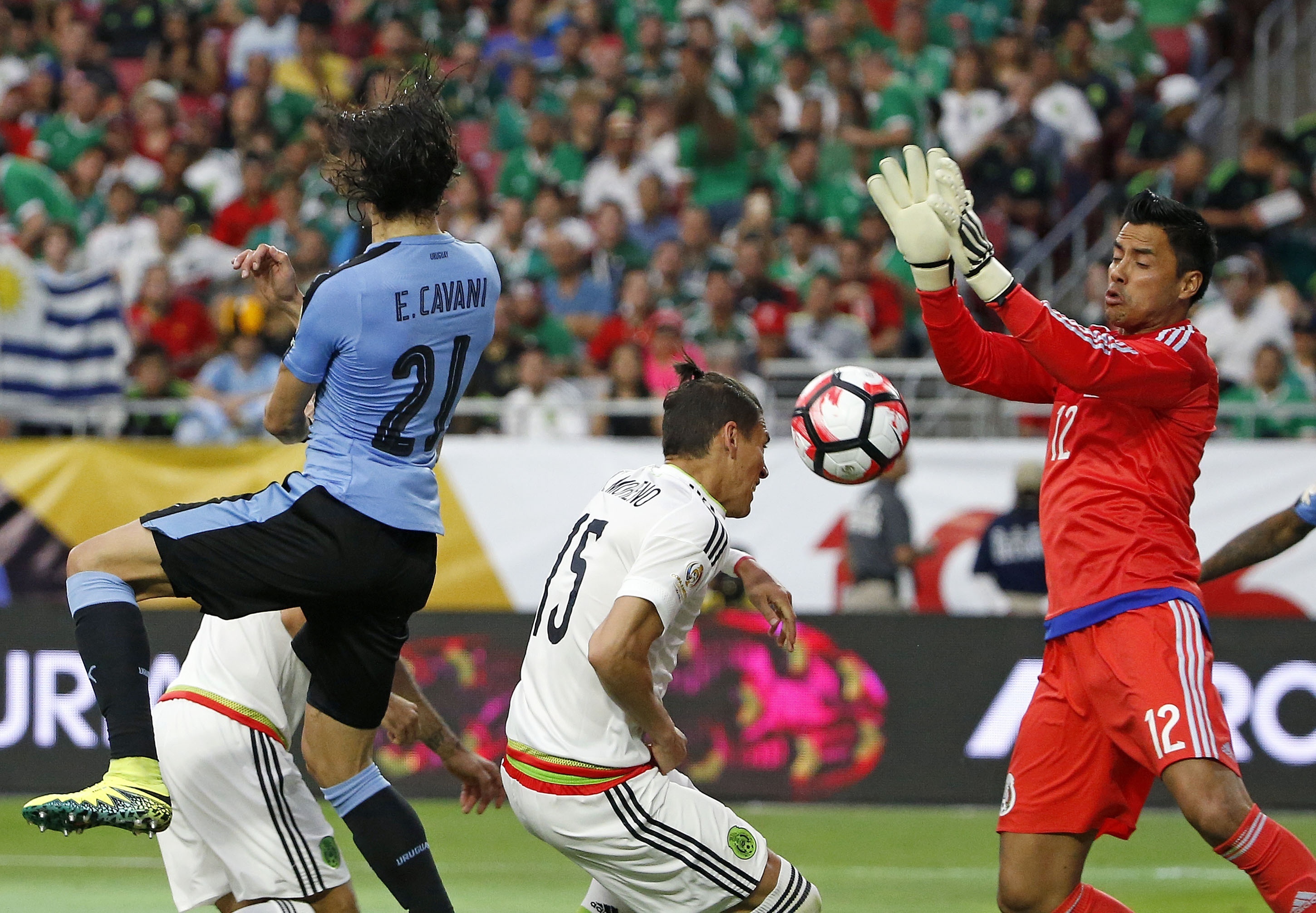 Mexico's Alfredo Talavera (12) makes a save on a shot by Uruguay's Edinson Cavani (21) as Mexico's Hector Moreno (15) defends during the second half of a Copa America group C soccer match at University of Phoenix Stadium Sunday, June 5, 2016, in Glendale, Ariz. Mexico defeated Uruguay 3-1. (AP Photo/Ross D. Franklin)