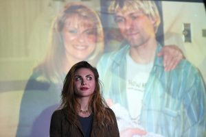 Kurt Cobain's daughter Frances Bean Cobain poses for a photograph in front of a home movie of Kurt at the opening of 'Growing Up Kurt' exhibition featuring personal items of Nirvana frontman Kurt Cobain at the museum of Style Icons in Newbridge