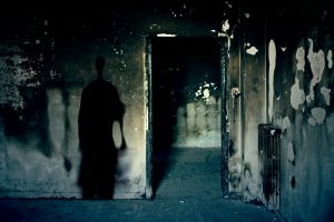 Scary scene with spooky shadow in a dark room of an abandoned building