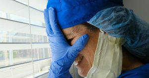 Sad, sick, crying overworked, female health care worker