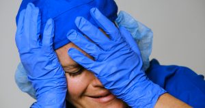 Sad, sick, crying, overworked, female health care worker