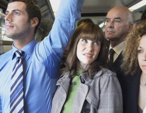 Female Commuter Standing by Man's Wet Armpit In Train
