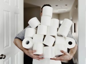 Man Carries Heap of Toilet Paper