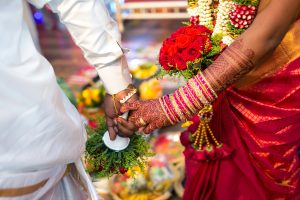 Bride And Groom Performing Traditional Rituals In Wedding